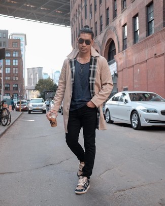 Beige Canvas Low Top Sneakers Outfits For Men: For a neat and relaxed look, wear a beige raincoat and black jeans — these pieces play really well together. The whole ensemble comes together if you complement your look with beige canvas low top sneakers.