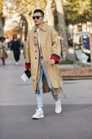 Beige Raincoat Outfits For Men: When the setting permits a laid-back look, you can dress in a beige raincoat and light blue jeans. Add a pair of white canvas low top sneakers to the mix for extra fashion points.