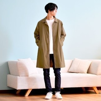 Beige Raincoat Outfits For Men: Try teaming a beige raincoat with navy jeans for a daily look that's full of style and personality. Introduce a pair of white canvas low top sneakers to the equation and ta-da: your outfit is complete.
