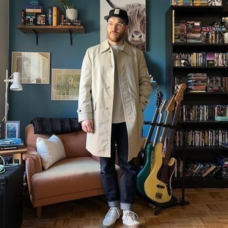 White Canvas Low Top Sneakers Outfits For Men: Wear a beige raincoat and navy jeans for a comfy look that's also put together. A good pair of white canvas low top sneakers pulls this getup together.