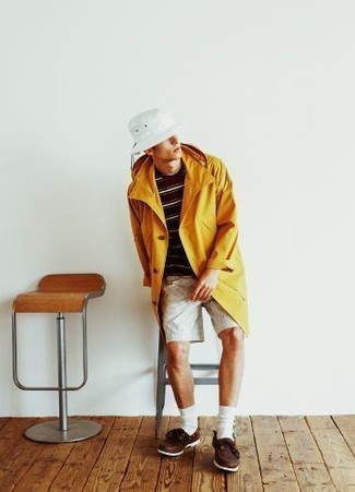 Men's Outfits 2022: For a look that's very simple but can be styled in a myriad of different ways, team an orange raincoat with grey vertical striped shorts. If not sure as to the footwear, stick to dark brown leather boat shoes.