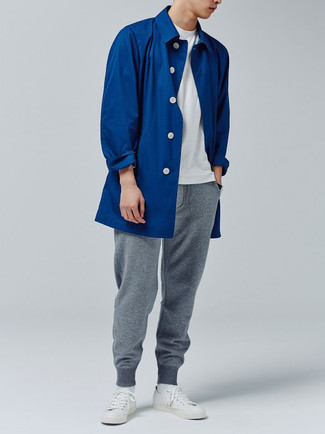 Sweatpants Outfits For Men: If you're facing a fashion situation where comfort is imperative, this combo of a blue raincoat and sweatpants is always a winner. Complement your look with white canvas low top sneakers and you're all set looking killer.