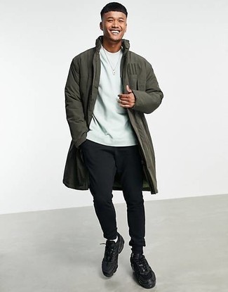 Olive Raincoat Outfits For Men: Consider teaming an olive raincoat with black and white sweatpants to be both contemporary and stylish. Get a bit experimental when it comes to footwear and dress down this outfit by finishing off with black athletic shoes.