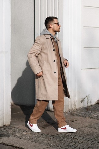 Beige Raincoat Outfits For Men: Rock a beige raincoat with brown chinos for relaxed dressing with a contemporary spin. Want to play it down on the shoe front? Introduce white and red leather high top sneakers to the equation for the day.