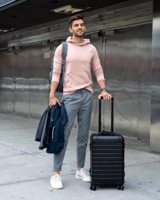 Charcoal Backpack Outfits For Men: A navy raincoat and a charcoal backpack are a great ensemble to have in your daily styling collection. Don't know how to complement this outfit? Finish with a pair of white low top sneakers to elevate it.