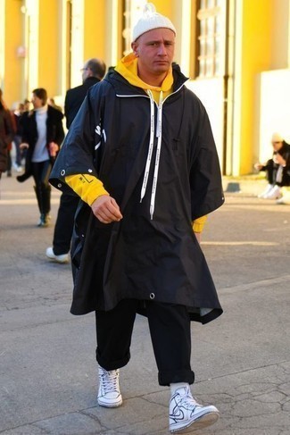 Men's Black Raincoat, Yellow Hoodie, Black Chinos, White and Navy Leather High Top Sneakers