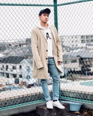 White and Navy Print Hoodie Outfits For Men: A white and navy print hoodie and light blue jeans make for the perfect foundation for a casually stylish ensemble. The whole getup comes together when you complement this look with white canvas low top sneakers.