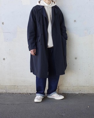 Navy Raincoat Outfits For Men: If you need to feel confident in your ensemble, team a navy raincoat with navy jeans. This look is completed nicely with a pair of white canvas low top sneakers.