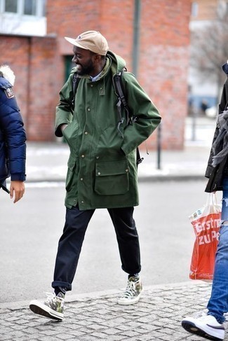 Tan Camouflage Canvas High Top Sneakers Outfits For Men: A dark green raincoat and navy chinos are the kind of a winning casual getup that you need when you have zero time to pick out a look. For a more relaxed touch, add tan camouflage canvas high top sneakers to this ensemble.
