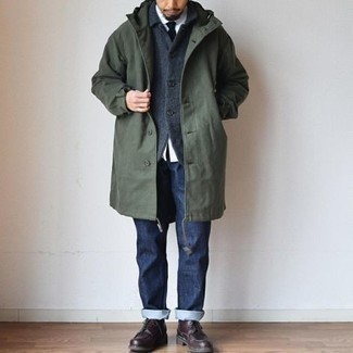 Olive Raincoat Outfits For Men: Stylish yet practical, this getup is assembled from an olive raincoat and navy jeans. For something more on the classier end to finish off this look, complement your outfit with dark brown leather derby shoes.