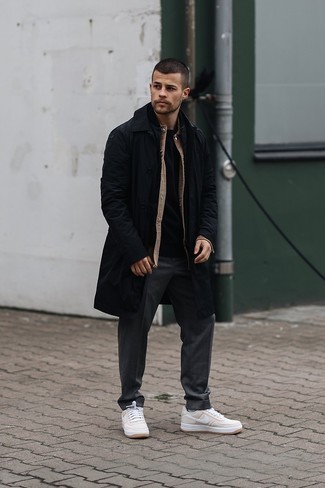 Beige Leather Low Top Sneakers Outfits For Men: You'll be surprised at how easy it is for any gentleman to throw together this casual getup. Just a black raincoat and charcoal chinos. Beige leather low top sneakers are a fitting pick here.