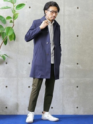 Navy Raincoat Outfits For Men: If you're on a mission for a casual and at the same time dapper look, consider pairing a navy raincoat with olive chinos. White canvas low top sneakers integrate well within a great deal of ensembles.