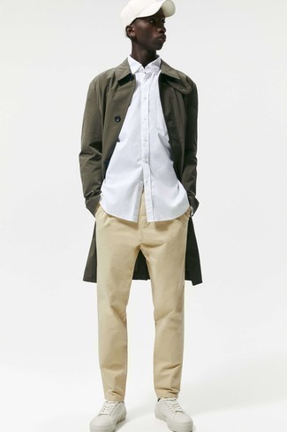 Olive Raincoat Outfits For Men: Who said you can't make a fashionable statement with an off-duty look? Draw the attention in an olive raincoat and beige chinos. Consider a pair of white leather low top sneakers as the glue that brings your look together.
