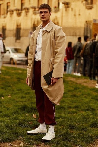 Burgundy Sweatpants Outfits For Men: A tan raincoat and burgundy sweatpants are absolute menswear must-haves that will integrate perfectly within your current off-duty fashion mix. Introduce white canvas low top sneakers to this getup and ta-da: this look is complete.