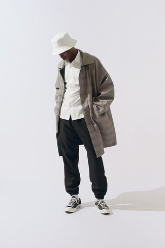 Grey Check Raincoat Outfits For Men: To don an off-duty outfit with an urban take, pair a grey check raincoat with black sweatpants. Add a pair of black and white canvas low top sneakers to the equation to easily dial up the fashion factor of any ensemble.