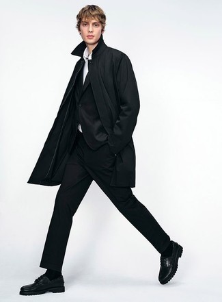 Black Suit Outfits: For refined style with a twist, you can easily rely on a black suit and a black raincoat. To infuse a more laid-back feel into this ensemble, complement your outfit with black leather boat shoes.