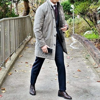 Grey Raincoat Outfits For Men: This combo of a grey raincoat and a navy suit couldn't possibly come across as anything other than ridiculously sharp and refined. You can get a little creative in the footwear department and complement your getup with a pair of dark brown leather derby shoes.