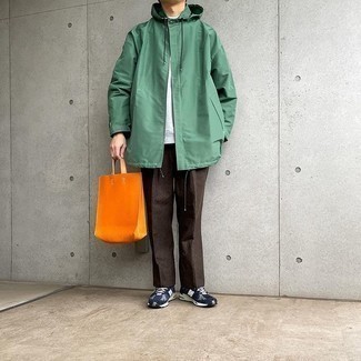 Men's Outfits 2021: Stylish yet comfortable, this look combines a green raincoat and dark brown chinos. Introduce a pair of navy and white athletic shoes to this getup to add a hint of stylish nonchalance to this getup.