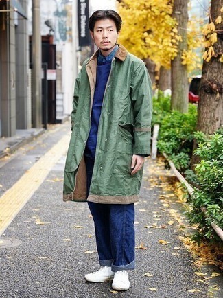 Olive Raincoat Outfits For Men: An olive raincoat and navy jeans are the kind of a fail-safe off-duty outfit that you so terribly need when you have no extra time. Introduce white canvas low top sneakers to this outfit and you're all done and looking amazing.