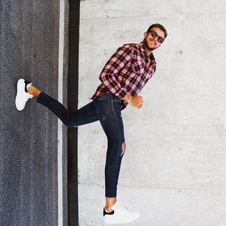 Men's Red and Black Plaid Long Sleeve Shirt, Navy Ripped Skinny Jeans, White and Black Leather Low Top Sneakers, Dark Brown Sunglasses