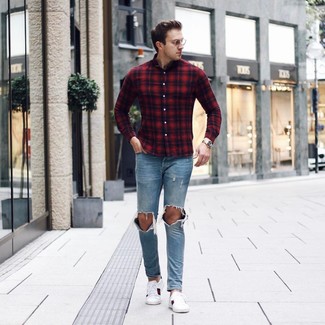 Red and Navy Plaid Long Sleeve Shirt Outfits For Men: A red and navy plaid long sleeve shirt and light blue ripped jeans will inject your look with a carefree, cool-kid vibe. Complement this ensemble with white print leather low top sneakers to completely jazz up the getup.