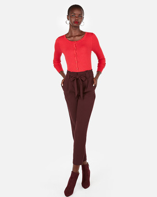 Red Cardigan Outfits For Women: If the situation calls for a polished yet knockout look, you can easily opt for a red cardigan and burgundy tapered pants. Add burgundy suede ankle boots to this ensemble and the whole look will come together quite nicely.