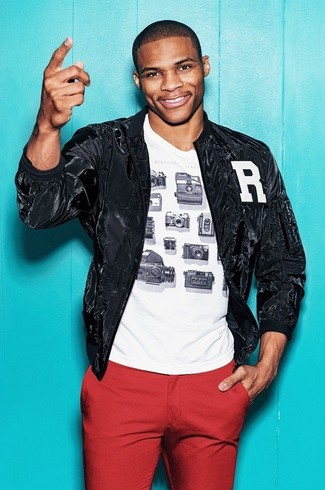 Russell Westbrook wearing Red Chinos, White and Black Print Crew-neck T-shirt, Black Bomber Jacket