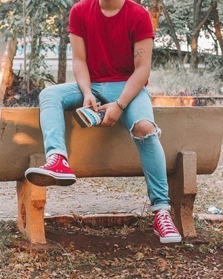 Red Crew-neck T-shirt Outfits For Men: A red crew-neck t-shirt and light blue ripped jeans are essential in any man's versatile casual arsenal. A pair of red canvas high top sneakers will pull your whole outfit together.