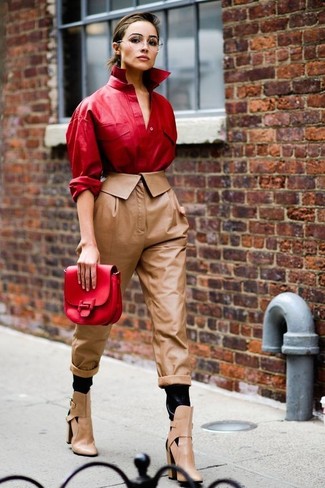 Brown Leather Tapered Pants Outfits For Women: Go for a refined getup in a red leather dress shirt and brown leather tapered pants. As for footwear, complement your outfit with a pair of tan cutout leather ankle boots.