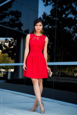 You can be sure you'll look incredibly stunning in a red lace fit and flare dress. We're totally digging how a pair of gold leather heeled sandals makes this outfit complete.