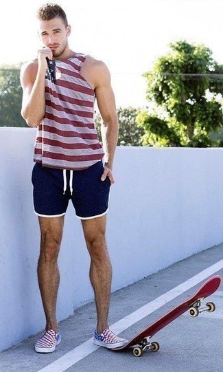 Navy Sports Shorts Outfits For Men: A red horizontal striped tank and navy sports shorts are amazing menswear must-haves that will integrate perfectly within your daily arsenal. To bring some extra fanciness to your outfit, add a pair of red check canvas slip-on sneakers to the equation.