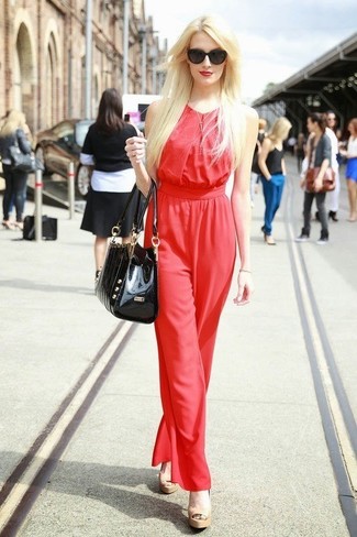 Want to inject your wardrobe with some elegant chic? Rock a red jumpsuit. For something more on the classier side to finish this look, complement this outfit with tan leather heeled sandals.