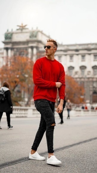 Red Sweatshirt Outfits For Men: This combo of a red sweatshirt and black ripped skinny jeans is on the casual side yet it's also sharp and really sharp. For a more sophisticated touch, why not introduce a pair of white leather low top sneakers to the equation?