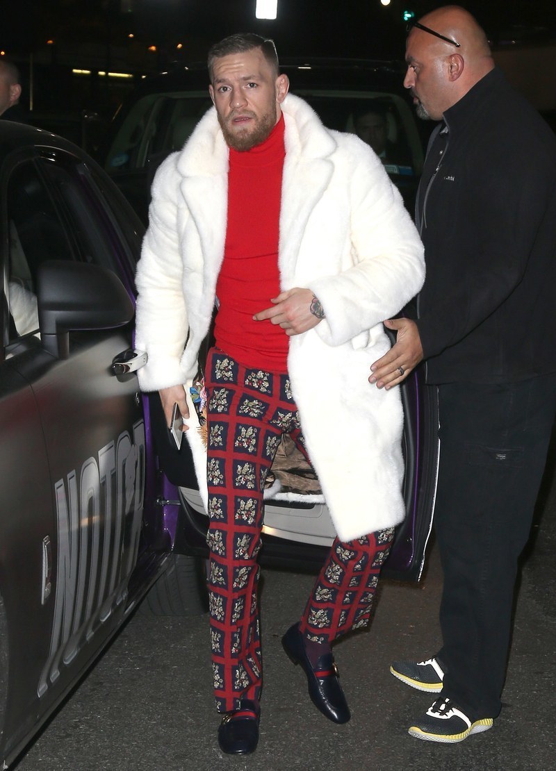 Conor McGregor wearing Red Turtleneck, Black Print Dress Pants, Black Loafers, Dark Purple Socks | Lookastic