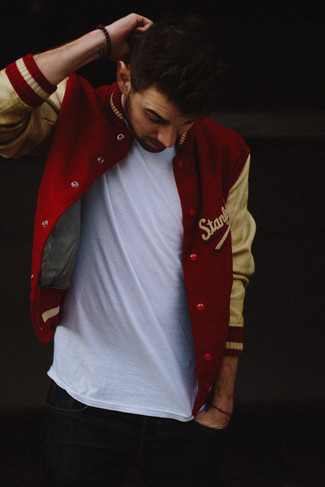 Red Varsity Jacket Outfits For Men: Try pairing a red varsity jacket with navy jeans for both stylish and easy-to-wear ensemble.