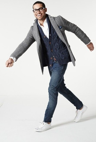 Teaming a navy shawl cardigan with navy jeans is a great pick for a casually cool look. When this ensemble appears all-too-classic, play it down with white low top sneakers.