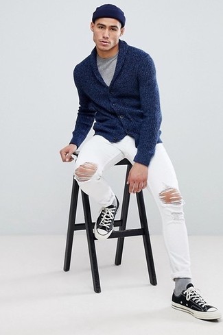 Navy Cardigan Outfits For Men: Showcase your prowess in menswear styling by pairing a navy cardigan and white ripped jeans for a laid-back look. The whole ensemble comes together if you introduce black and white canvas low top sneakers to the equation.