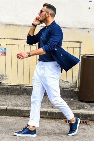 Navy Leather Low Top Sneakers Outfits For Men: A blue shawl cardigan and white chinos matched together are the perfect outfit for guys who appreciate elegant looks. A pair of navy leather low top sneakers adds just the right amount of stylish effortlessness to this ensemble.