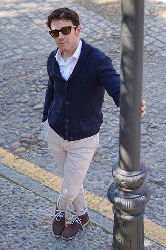 Beige Chinos Spring Outfits: This combination of a navy shawl cardigan and beige chinos is the perfect base for a multitude of combos. This look is finished off really well with dark brown leather desert boots. So if you're on the lookout for a neat ensemble that will take you from winter to spring, this one fits the bill.