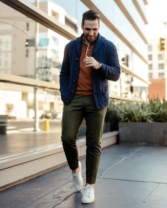 Tobacco Polo Outfits For Men: A tobacco polo and olive chinos are the kind of a tested casual outfit that you so terribly need when you have no time. Add white leather low top sneakers to this ensemble and you're all done and looking killer.