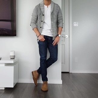 Grey Shawl Cardigan Outfits For Men: Wear a grey shawl cardigan and navy jeans to feel fully confident in yourself and look trendy. This look is finished off really well with a pair of brown suede desert boots.