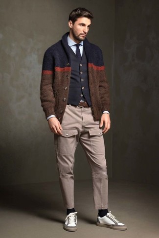 Dark Brown Shawl Cardigan Outfits For Men: You'll be amazed at how extremely easy it is for any guy to get dressed like this. Just a dark brown shawl cardigan teamed with beige cargo pants. On the fence about how to finish off? Add a pair of white leather low top sneakers to jazz things up.