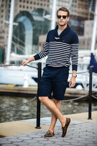 Brown Leather Boat Shoes Outfits: This pairing of a navy and white horizontal striped shawl-neck sweater and navy shorts is the ultimate casual outfit for any gentleman. Look at how nice this getup is completed with a pair of brown leather boat shoes.