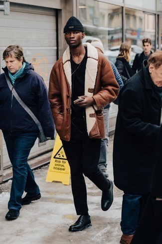 Black Jeans Outfits For Men: For a never-failing laid-back option, you can never go wrong with this combo of a brown shearling coat and black jeans. And if you need to easily polish up this getup with shoes, complete this look with black leather derby shoes.