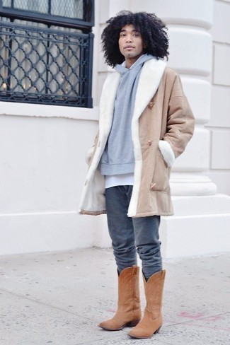 Cowboy Boots Outfits For Men: Extremely dapper and functional, this relaxed combination of a tan shearling coat and charcoal sweatpants will provide you with amazing styling possibilities. Does this outfit feel all-too-fancy? Let a pair of cowboy boots mix things up a bit.