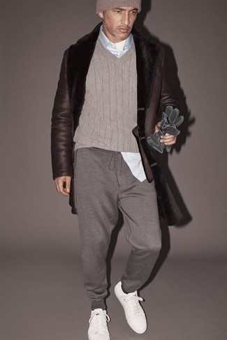 Dark Brown Shearling Coat Outfits For Men: Try teaming a dark brown shearling coat with grey sweatpants for a casual and trendy getup. Let your outfit coordination sensibilities truly shine by finishing with white canvas low top sneakers.
