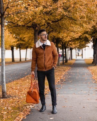 500+ Winter Outfits For Men: Why not reach for a tobacco shearling jacket and black chinos? These items are super practical and look good teamed together. You can stick to the classic route in the shoe department by wearing a pair of black leather chelsea boots. This look is both stylish and winter-friendly. Double win!