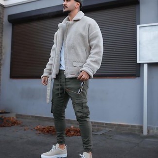 Olive Beanie Outfits For Men: For comfort dressing with a city style take, go for a beige shearling jacket and an olive beanie. Add beige canvas low top sneakers to the mix for an added dose of refinement.