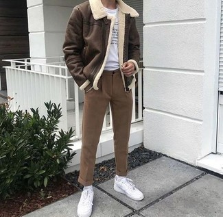 Dark Brown Shearling Jacket Outfits For Men: Marry a dark brown shearling jacket with brown chinos to effortlessly deal with whatever this day has in store for you. For something more on the casual and cool end to round off this outfit, introduce white leather low top sneakers to your outfit.
