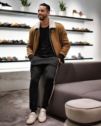 Tan Shearling Jacket Outfits For Men: This off-duty pairing of a tan shearling jacket and black chinos is very easy to pull together in no time flat, helping you look amazing and prepared for anything without spending a ton of time rummaging through your closet. Beige suede low top sneakers will give a playful vibe to your ensemble.